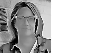 Black and white portrait of a woman wearing glasses.