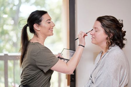 Makeup Artist applying makeup to the Bride.