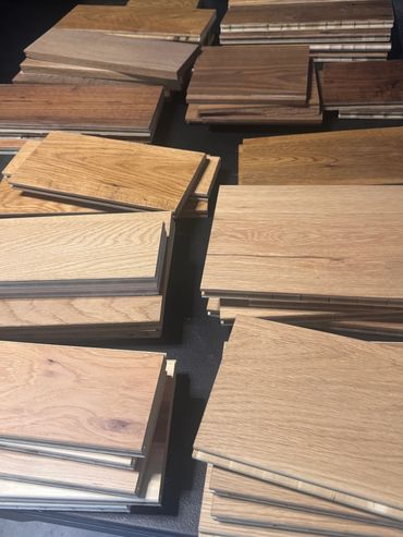 Stacks of various wood flooring planks in different shades.