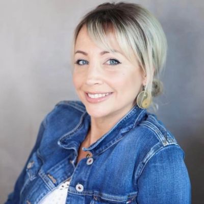 Smiling woman wearing a denim jacket.