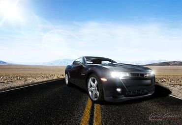 Composite of a Chevrolet Camaro parked sideways on the roadway in a desert scene