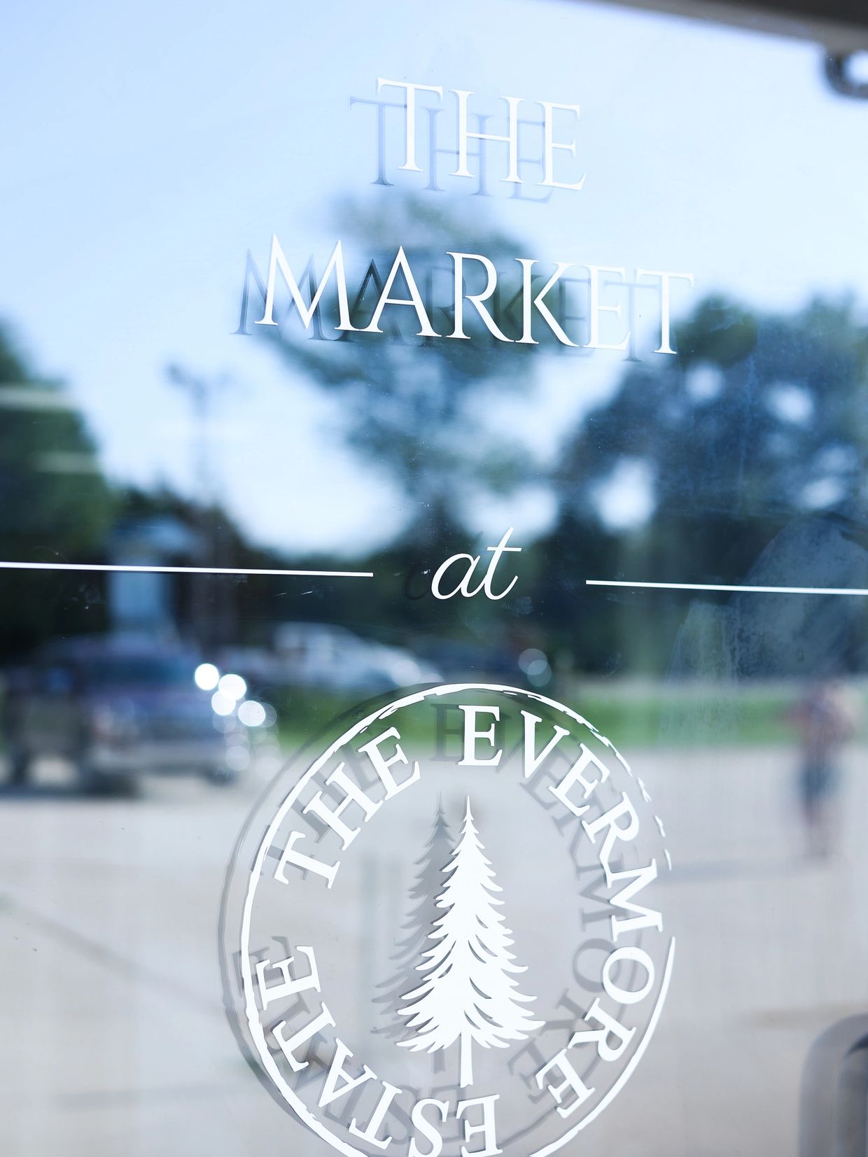 Glass window with the text 'The Market at The Evermore Estate'.