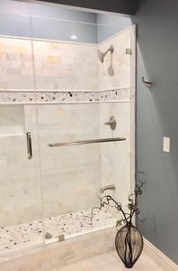 Walk in marble shower with glass door