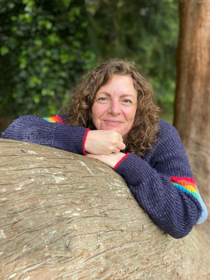 A picture of Louise Fenner in a tree, smiling.