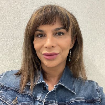 Person smiling wearing a denim jacket.