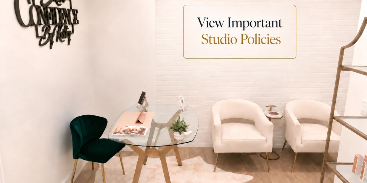 Modern studio waiting area with chairs and glass table.