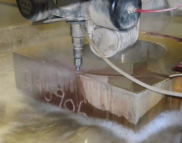 Waterjet cutting a thick stone slab with precision.