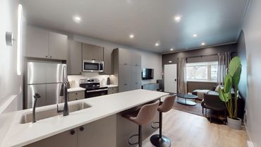 Modern kitchen and living room with minimalist design.