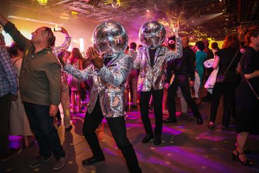 Atmosphere talent engages with client's during a corporate reception.