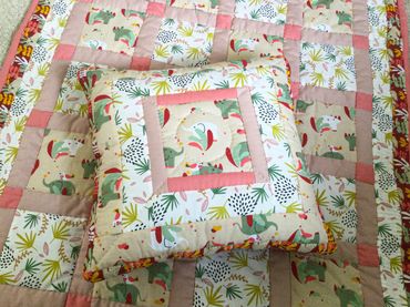 Hand Quilted baby Quilt with matching cushion - jungle prints with pastels © Sally Quick
