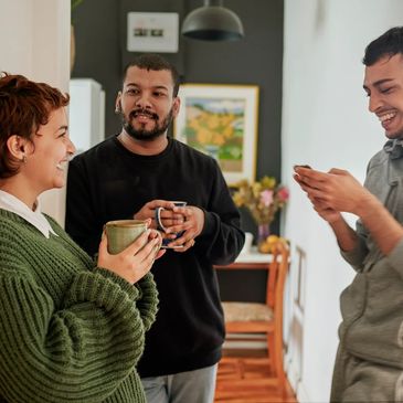 Adri friends inside the home with hold the coffee mug and discussing each other