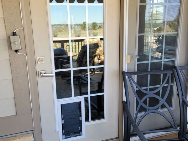 Hale pet door with a secure cover is installed with a cut down for the dogs with smaller legs in Cas
