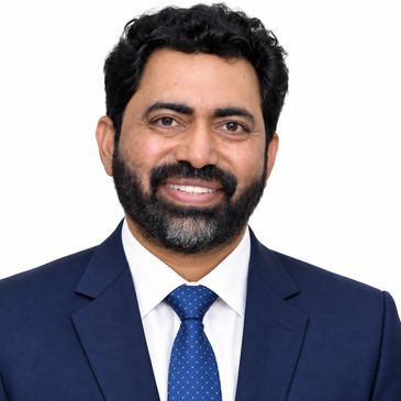 Smiling man in blue suit and tie.