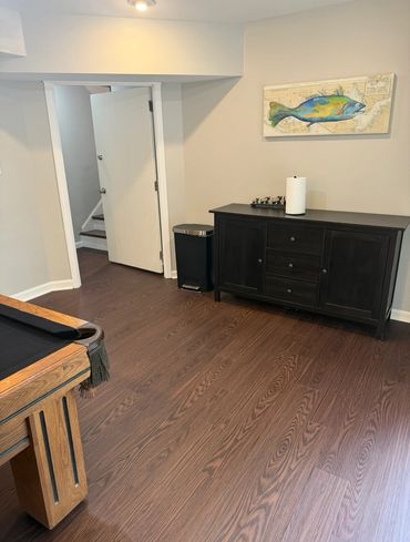Cozy game room corner with pool table and dark wood cabinet.
