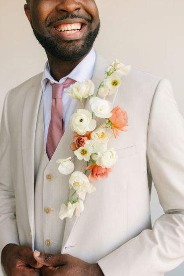 Our stunning and dynamic, floral, full lapel piece popping off of the jacket lapel!