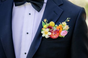 Sunset hued pocket square boutonniere