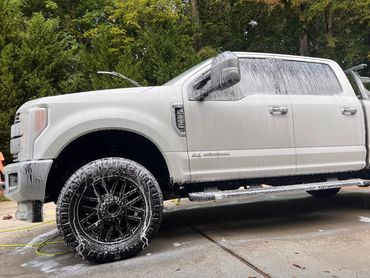 Vehicle foamed and being washed