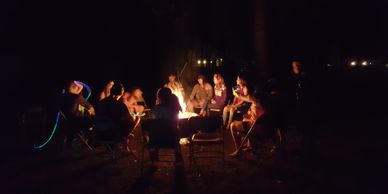 Young people around a campfire at night
