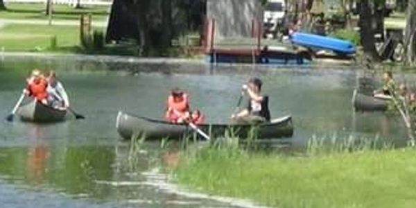 Family canoeing on peaceful canal
