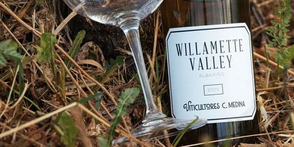 Bottle of Willamette Valley Albariño wine with a glass outdoors.