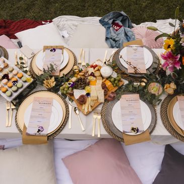 long table with tablescape and large floral arrangement add-on for luxe pop up picnic experience
