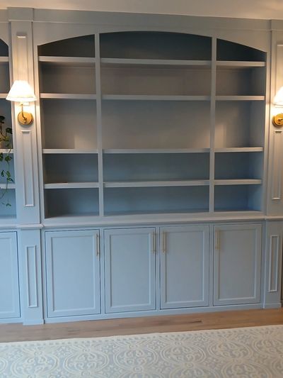 ustom built-in cabinetry finished with Milesi wood coatings and arched shelving.