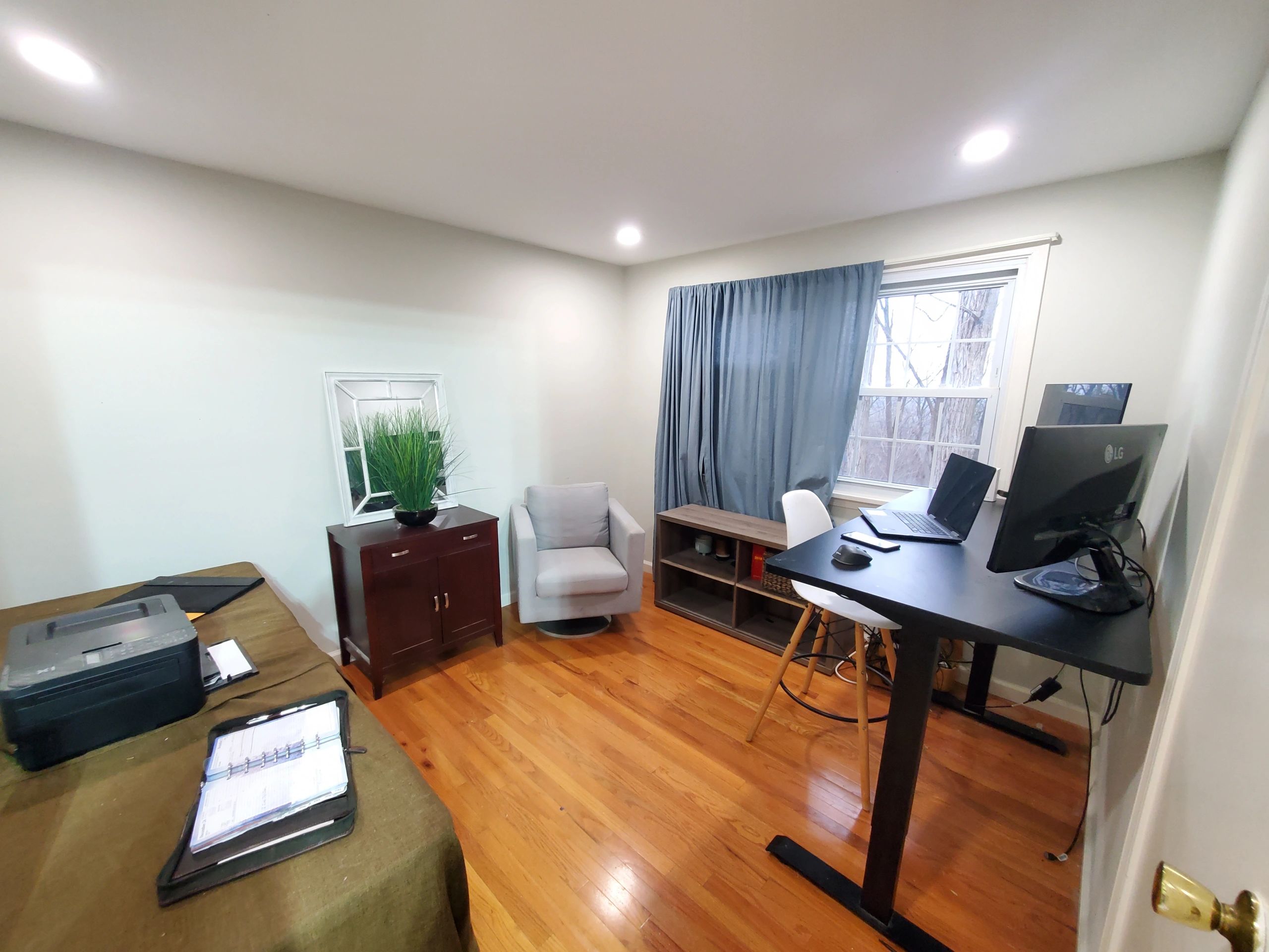 Cozy home office with wooden floors and modern furniture.
