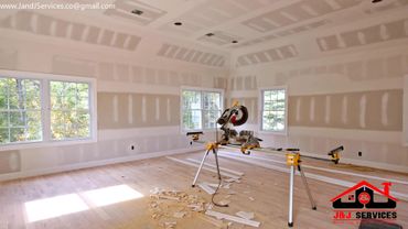 miter saw on a stand and new drywall