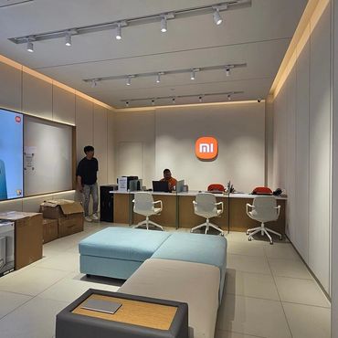 Modern Xiaomi store interior with product displays and seating area.