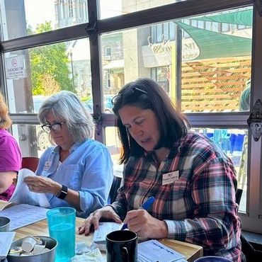 Paula at Sips, in Plattsburgh, at a postcarding party.