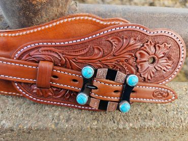 Custom tooled leather spur straps with custom buckles with turquoise detail