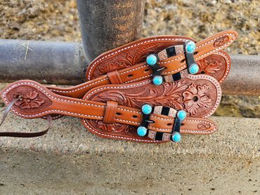 Custom floral tooled spur straps with custom turquoise buckles