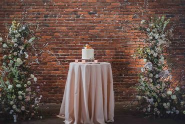 Wedding cake set with large florals set around. 