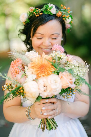Bride with her pastel bridal bouquet and floral crown. 