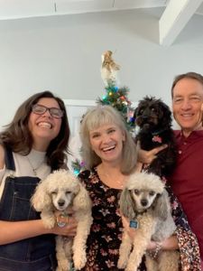 A group of people with puppies