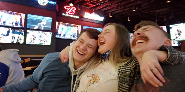 Student workers laughing together at company happy hour