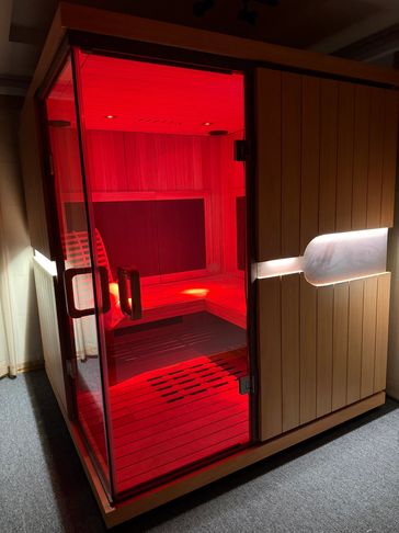 Modern sauna room glowing with red light.