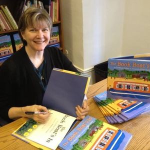 A woman signing books