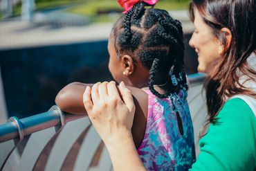 female grandparent volunteer with young african american girl