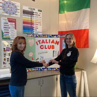 Boardmember Bernadette provides a donation to PHS Italian language class instructor Ms. Kanyuk