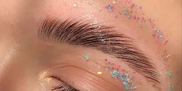 professionally designed eyebrows with sparkles around them