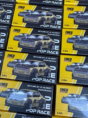 Multiple 1/64 scale model car boxes featuring Skyline GT-R V8 Drift (Hakosuka).