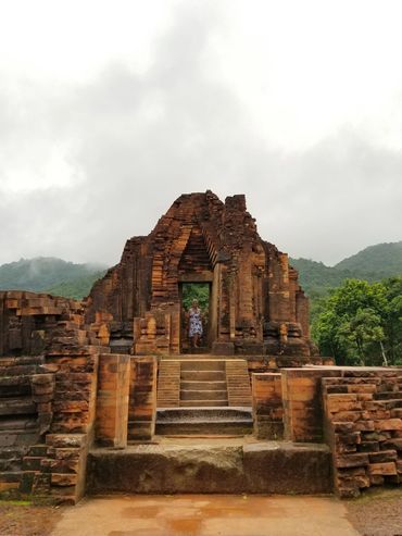 Ancient brick temple entrance with a person standing inside.