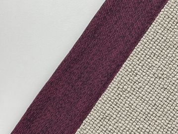 Close-up of textured fabric in burgundy and beige colors.