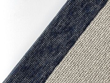 Close-up of textured fabric with dark blue and beige sections.