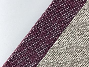 Close-up of textured fabric with maroon and beige sections.