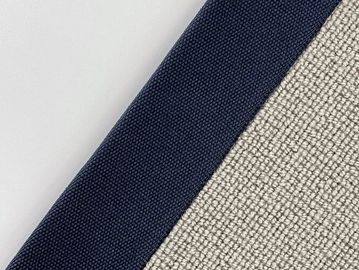 Close-up of fabric with navy blue and light beige colors.