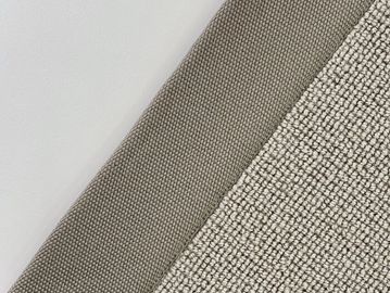 Close-up of textured fabric in neutral tones with a beige woven pattern.