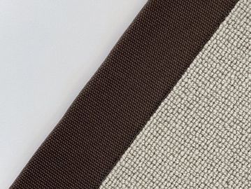 Close-up of textured fabric with brown border and beige woven material.