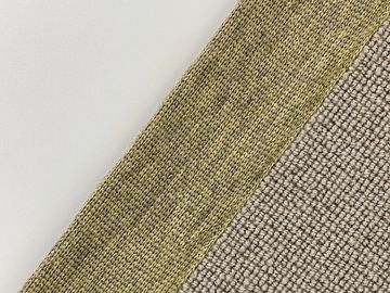 Close-up of two different textured fabrics in beige and olive colors.